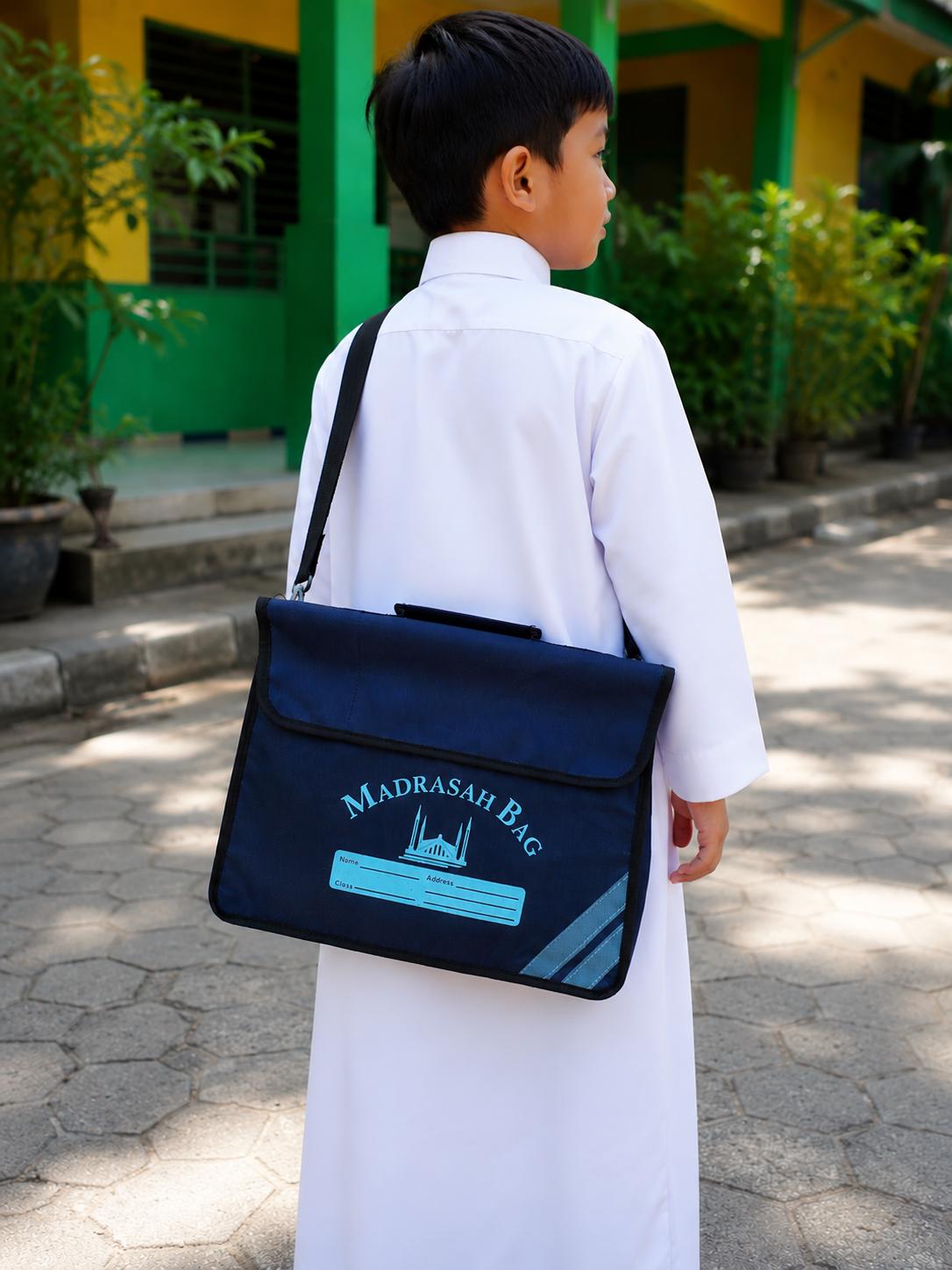 Child carrying a navy blue Madrasah school shoulder bag for Quran class and school